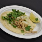 Shredded pork taco with cilantro and onions