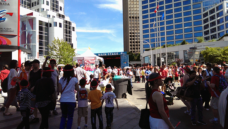 Crowds enjoying the festivities during Canada Day at Canada Place in downtown Vancouver.